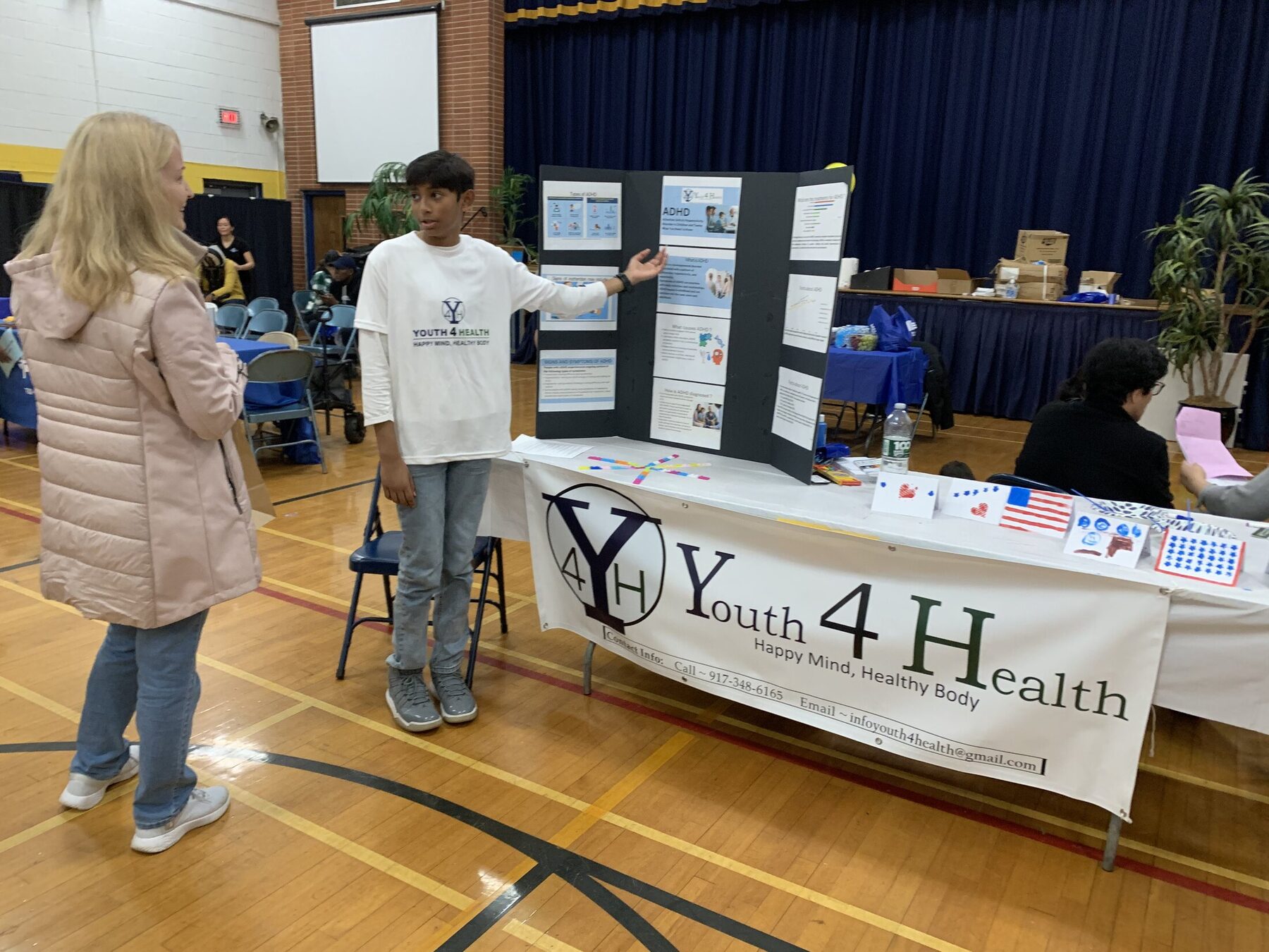 Answering questions at the Lake Nelson wellness event