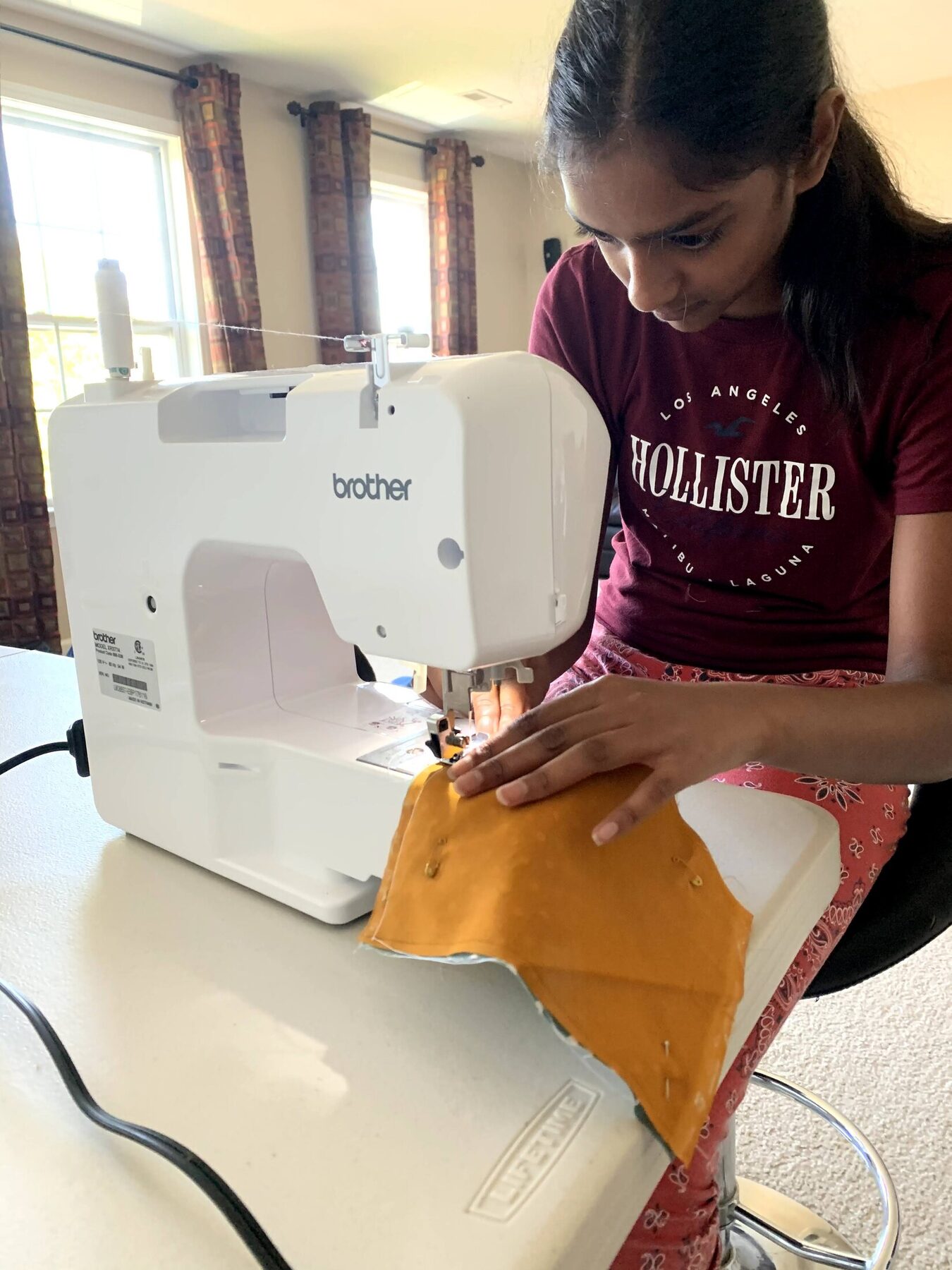 Saanvi sewing a reusable cloth mask