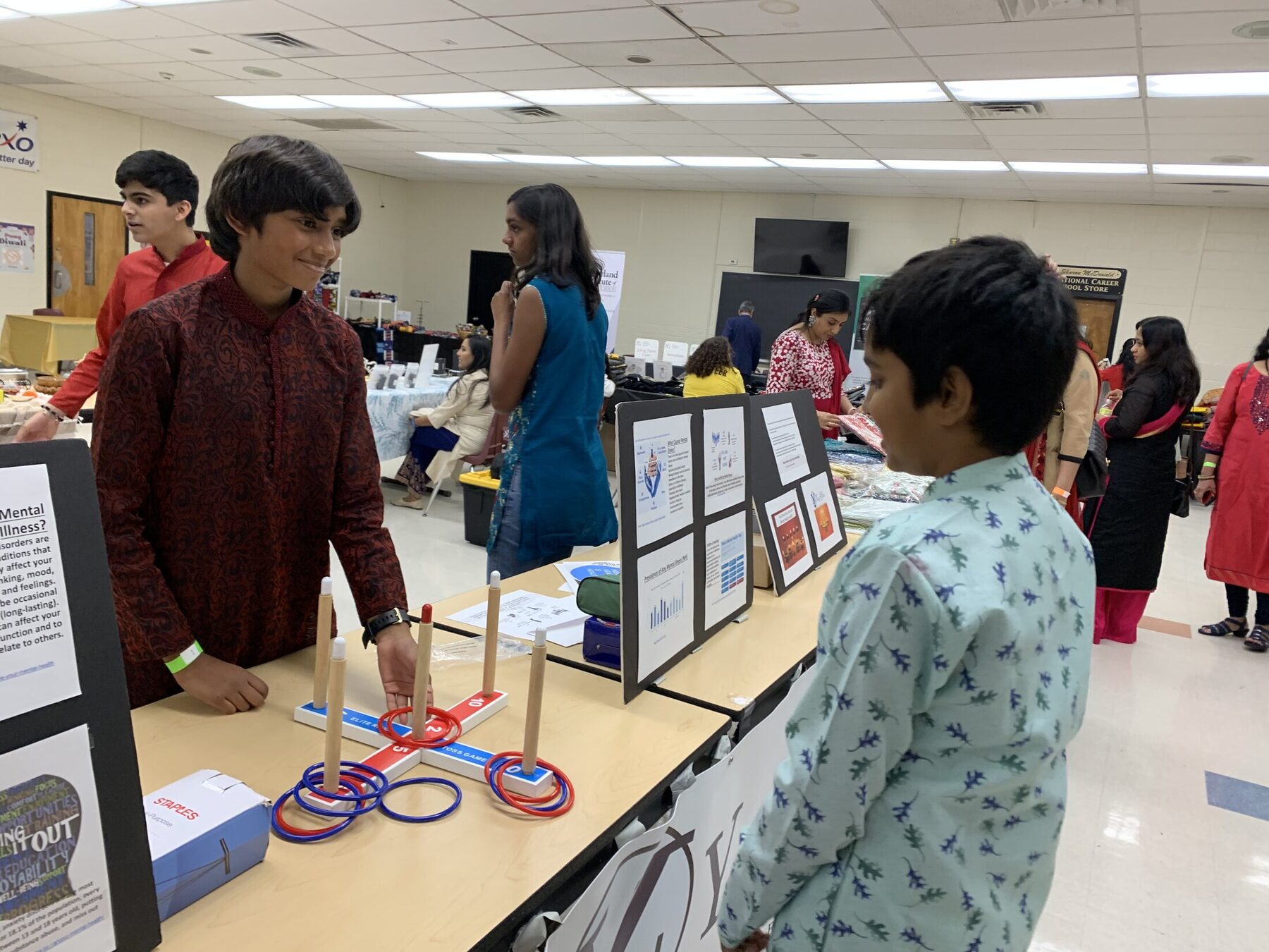 Youth volunteers explaining the display to younger attendees