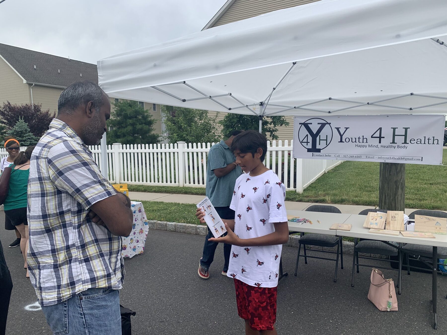 Youth volunteers explaining the activity to visitors
