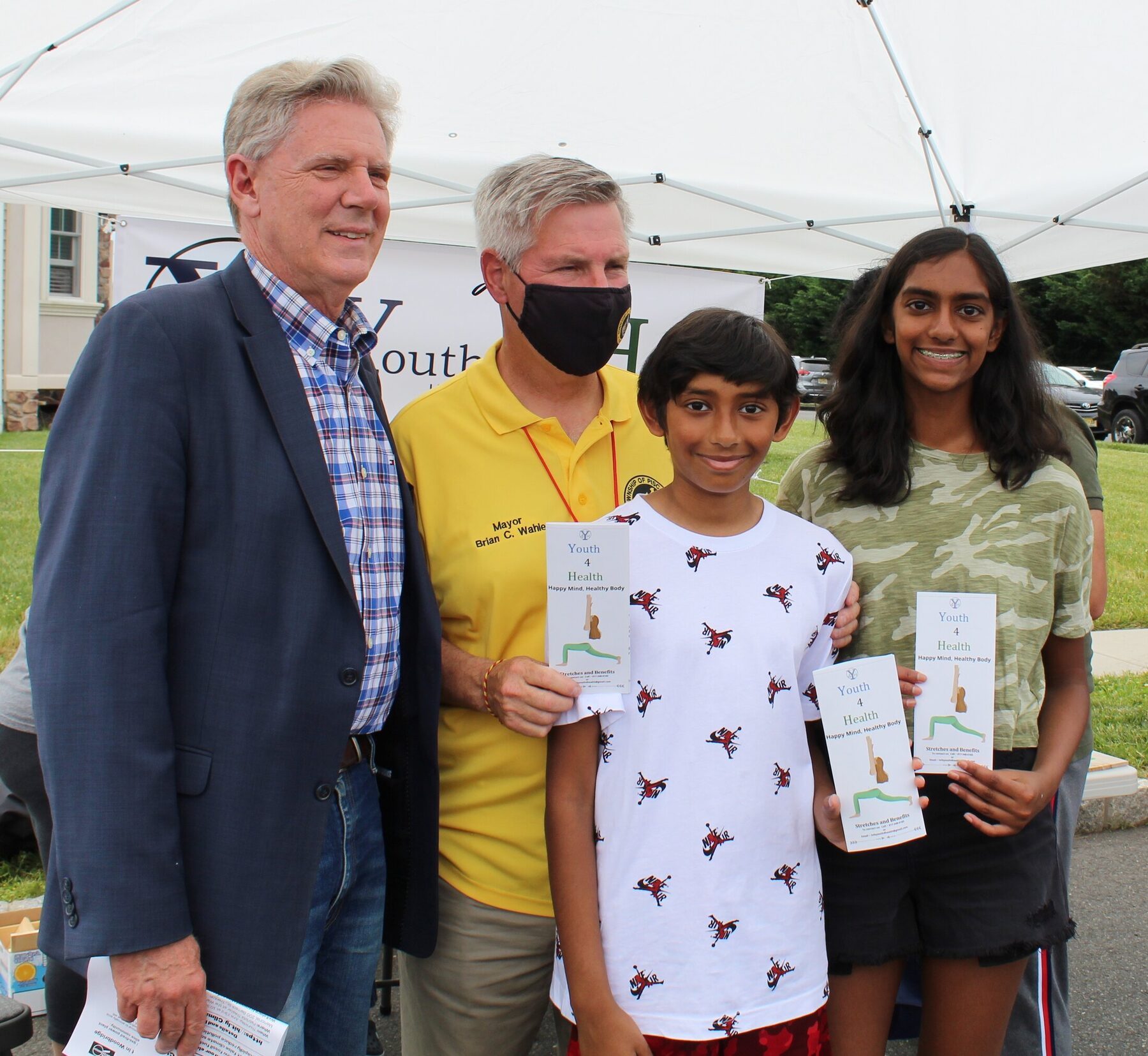 Youth volunteers with community leaders at the street fair